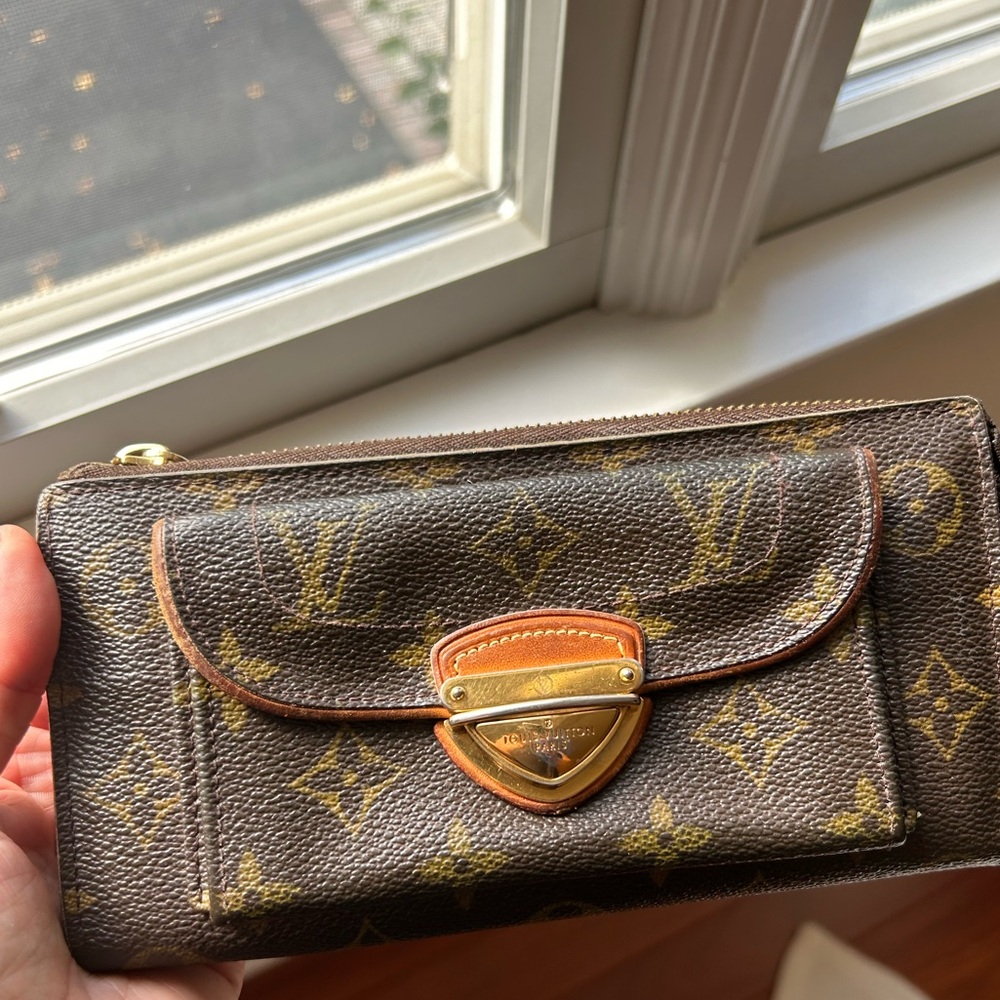 Vintage Louis Vuitton organizer wallet with overall wear.